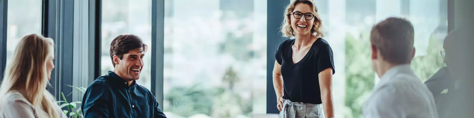 Three people one girl and two boys girl is standing and saying something to two boys that are sitting